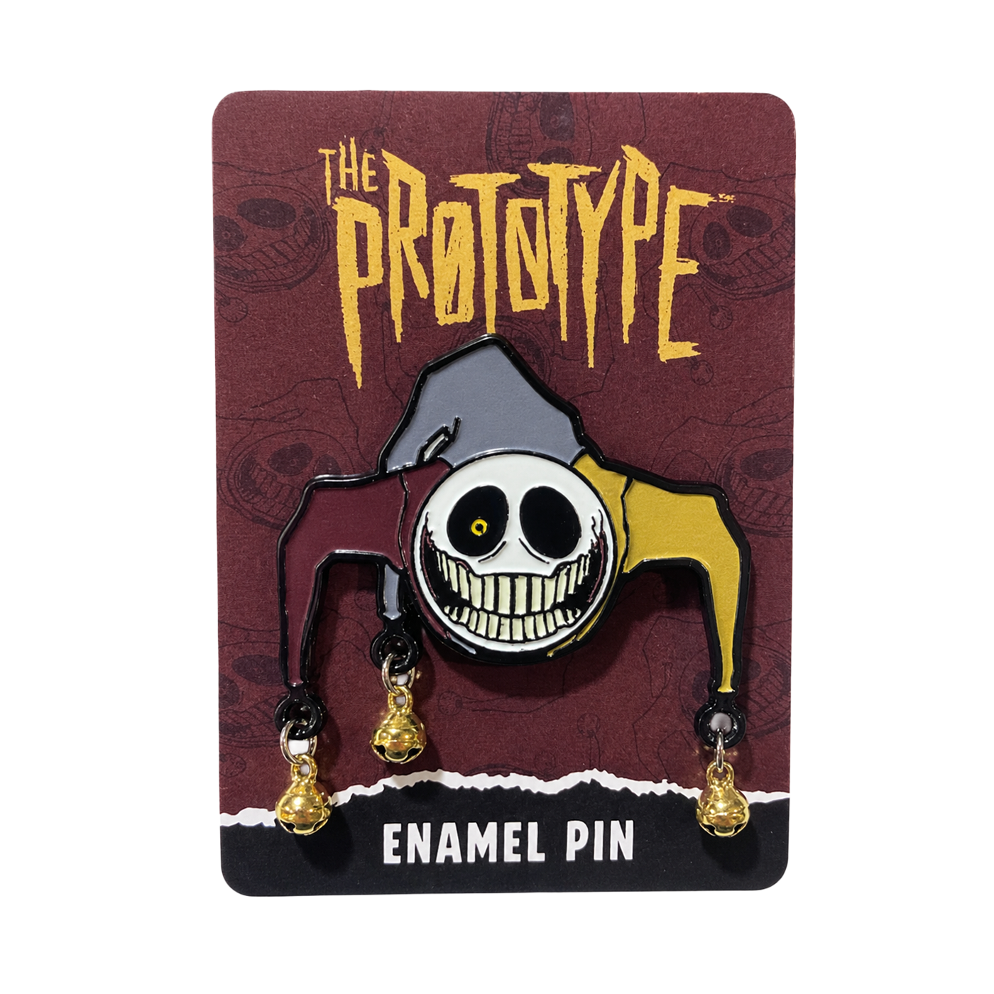A Prototype-themed enamel pin featuring a stylized clown face with dangling gold bells, mounted on a dark brown backing card printed with the 'The Prototype' logo and 'Enamel Pin' text.