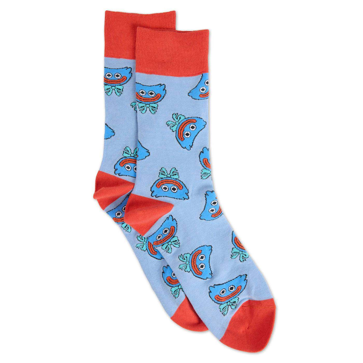 A pair of light blue crew socks with a repeating pattern of smiling huggy wuggy faces, featuring solid red cuffs, heels, and toes.